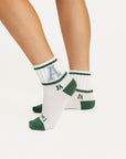 White socks featuring green and blue text on a white background