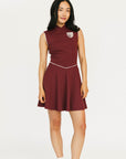 Woman wearing a maroon dress with a white logo on a white background