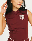 Woman wearing a maroon dress with a white logo on a white background
