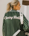 Person wearing a green and white striped cardigan with 'Chasing Balls' text.