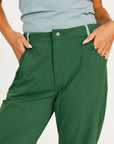 Green pants worn by a person on a white background