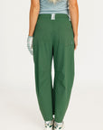 Green pants worn by a person on a white background