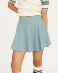 Smoke blue Manhattan skirt worn by a person on a white background