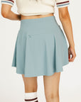 Smoke blue Manhattan skirt worn by a person on a white background