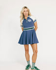 Woman wearing a blue and white dress with a logo on a white background