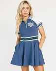 Woman wearing a blue and white dress with a logo on a white background