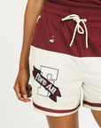 Person wearing the Fore All Fletcher short in merlot with branding on a plain background