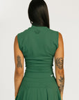 Woman wearing a green dress Manhattan Mock Neck against a white background