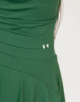 Woman wearing a green dress Manhattan Mock Neck against a white background