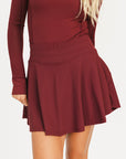 Merlot Marie long-sleeve top and Manhattan skirt set on a white background