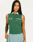 Woman wearing a green sleeveless golf polo with 'Fore All' text on a white background