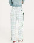 Person wearing green plaid pants with a FORE ALL logo on a white background
