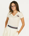 Woman wearing an angora Brooklyn Polo featuring a 'Fore All' logo on the left chest.