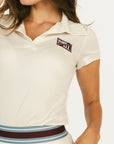 Woman wearing an angora Brooklyn Polo featuring a 'Fore All' logo on the left chest.