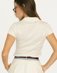 Woman wearing an angora Brooklyn Polo featuring a 'Fore All' logo on the left chest.
