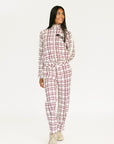 Woman wearing a merlot and white plaid Lyla Jacket on a plain background