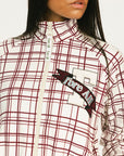 Woman wearing a merlot and white plaid Lyla Jacket on a plain background