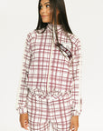 Woman wearing a merlot and white plaid Lyla Jacket on a plain background
