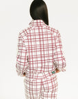 Woman wearing a merlot and white plaid Lyla Jacket on a plain background