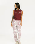 Person wearing red plaid Fore All Sloan Pants on a white background. Featuring a double snap closure and side seam pockets.