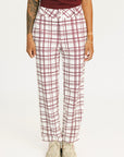 Person wearing red plaid Fore All Sloan Pants on a white background. Featuring a double snap closure and side seam pockets.