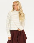 Woman wearing an angora and white Lottie Mock Neck with the Eleanor short in merlot.