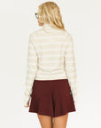 Woman wearing an angora and white Lottie Mock Neck with the Eleanor short in merlot.