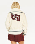 Person wearing a cream hoodie with 'FORE' text and maroon shorts on a white background