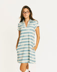 Woman wearing a blue and white striped Poppy Dress with text on a white background