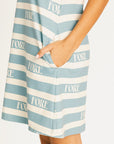 Woman wearing a blue and white striped Poppy Dress with text on a white background