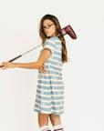 Woman wearing a blue and white striped Poppy Dress with text on a white background