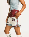 Person wearing the Fore All Fletcher short in merlot with branding on a plain background