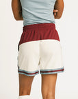 Person wearing the Fore All Fletcher short in merlot with branding on a plain background