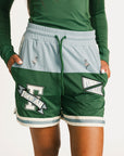 Green Fletcher athletic shorts with Fore All logos on a plain background