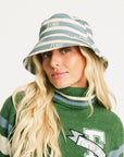 Person wearing the Fore All Austi Bucket Hat with a green sweater with a logo