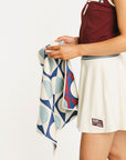 Person holding a patterned towel with a white background
