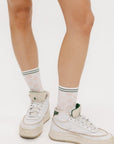 A model wearing pink/white checkered charlie crew socks on a white background.