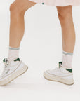 A model wearing pink/white checkered charlie crew socks on a white background.