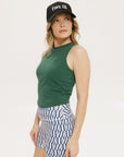 A pair of blue and white geometric shorts, knee-length, worn by a model paired with a green Lillee Tank.