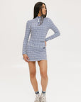 A woman wearing a mock neck, long sleeve Bea Base Mock top in an indigo and white pattern.