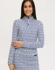 A woman wearing a mock neck, long sleeve Bea Base Mock top in an indigo and white pattern.