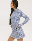 A woman wearing a mock neck, long sleeve Bea Base Mock top in an indigo and white pattern.