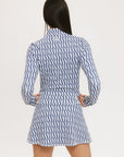 A woman wearing a mock neck, long sleeve Bea Base Mock top in an indigo and white pattern.