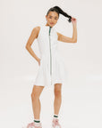 A woman models a white sleeveless dress with a zipper down the front, designed for comfort and movement.
