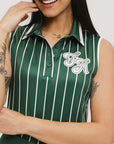 A female model wearing a sleeveless green pinstripe polo top with an applique logo on the chest.