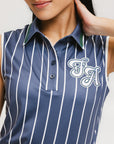 A woman wearing a sleeveless navy blue and white striped Moore Polo golf top.