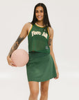 A female model wearing a green sleeveless tank top with 'Fore All' text and a logo on the chest, ribbed armholes, and a round neckline.