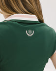 A woman wearing a green sleeveless polo with a striped collar and a v-neck.