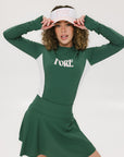A female model wearing a long sleeve green and white ribbed baselayer top with raglan sleeves and colorblocking.