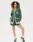 Person wearing a green and white striped cardigan with 'Chasing Balls' text.